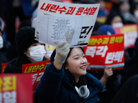 Tens of thousands of citizens gather across from the National Assembly in Yeouido, Seoul, South Korea, on December 8, 2024, holding signs th...