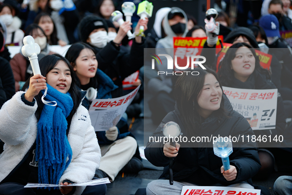 Tens of thousands of citizens gather across from the National Assembly in Yeouido, Seoul, South Korea, on December 8, 2024, holding signs th...