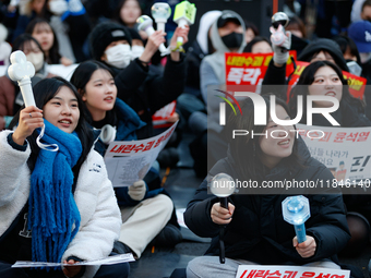 Tens of thousands of citizens gather across from the National Assembly in Yeouido, Seoul, South Korea, on December 8, 2024, holding signs th...