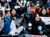 Tens of thousands of citizens gather across from the National Assembly in Yeouido, Seoul, South Korea, on December 8, 2024, holding signs th...