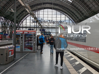 Travelers prepare for departure alongside an ICE train. On March 30, 2023, travelers are on Platform 6B at Frankfurt am Main Central Station...