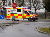 A Bavarian Red Cross ambulance with flashing blue lights is on a mission in Gauting, Bavaria, Germany, on December 8, 2024. (