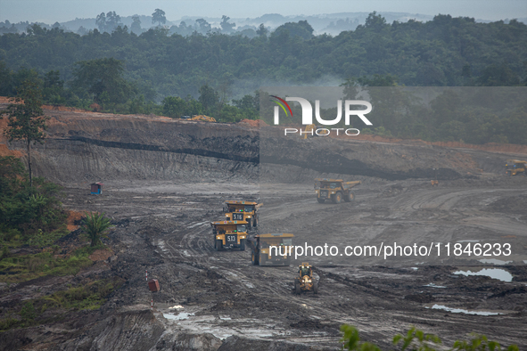 A coal mining truck operates at an opencast coalmine in Kalimantan, Indonesia, on December 8, 2024. Environmental activists express concern...