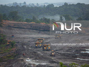 A coal mining truck operates at an opencast coalmine in Kalimantan, Indonesia, on December 8, 2024. Environmental activists express concern...