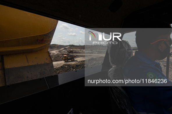 Heavy machinery operates at a coal mining site in South Kalimantan, Indonesia, on December 8, 2024. Environmental activists express concern...