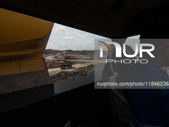 Heavy machinery operates at a coal mining site in South Kalimantan, Indonesia, on December 8, 2024. Environmental activists express concern...