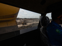 Heavy machinery operates at a coal mining site in South Kalimantan, Indonesia, on December 8, 2024. Environmental activists express concern...