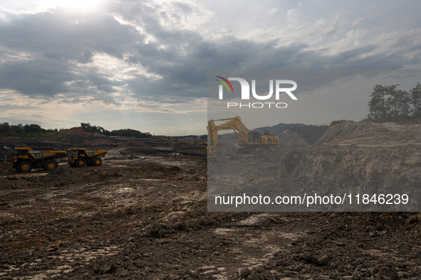 Heavy machinery operates at a coal mining site in South Kalimantan, Indonesia, on December 8, 2024. Environmental activists express concern...