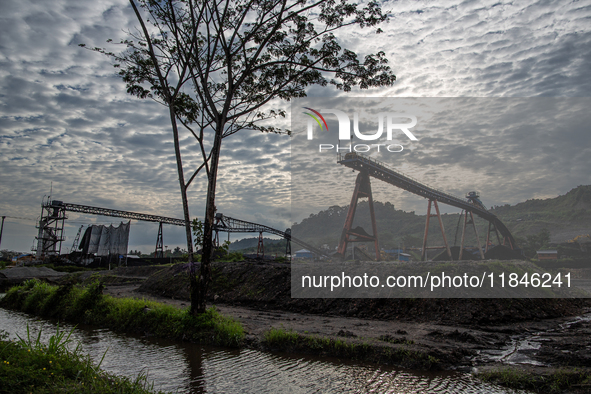 A conveyor belt and piles of coal are at a stockpile in Kalimantan, Indonesia, on December 8, 2024. Environmental activists express concern...