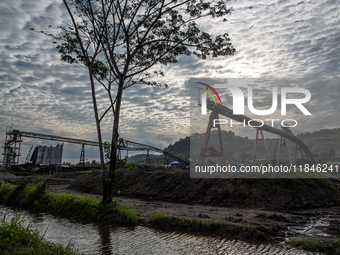 A conveyor belt and piles of coal are at a stockpile in Kalimantan, Indonesia, on December 8, 2024. Environmental activists express concern...