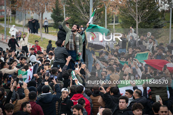 Syrian refugees living in the Onder district of Ankara, Turkey, celebrate the fall of Syrian President Bashar al-Assad after a rapid rebel o...