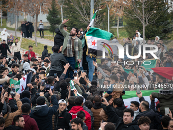 Syrian refugees living in the Onder district of Ankara, Turkey, celebrate the fall of Syrian President Bashar al-Assad after a rapid rebel o...