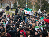 Syrian refugees living in the Onder district of Ankara, Turkey, celebrate the fall of Syrian President Bashar al-Assad after a rapid rebel o...