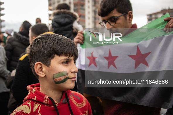 Syrian refugees living in the Onder district of Ankara, Turkey, celebrate the fall of Syrian President Bashar al-Assad after a rapid rebel o...