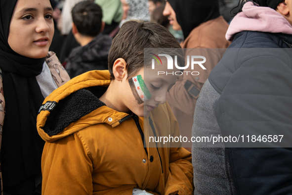 Syrian refugees living in the Onder district of Ankara, Turkey, celebrate the fall of Syrian President Bashar al-Assad after a rapid rebel o...