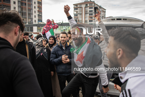 Syrian refugees living in the Onder district of Ankara, Turkey, celebrate the fall of Syrian President Bashar al-Assad after a rapid rebel o...