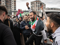 Syrian refugees living in the Onder district of Ankara, Turkey, celebrate the fall of Syrian President Bashar al-Assad after a rapid rebel o...