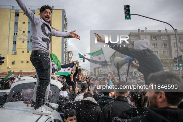 Syrian refugees living in the Onder district of Ankara, Turkey, celebrate the fall of Syrian President Bashar al-Assad after a rapid rebel o...