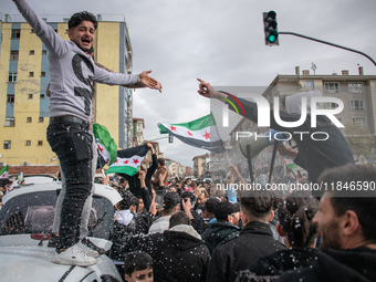 Syrian refugees living in the Onder district of Ankara, Turkey, celebrate the fall of Syrian President Bashar al-Assad after a rapid rebel o...