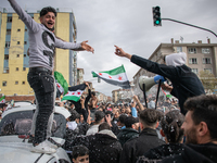 Syrian refugees living in the Onder district of Ankara, Turkey, celebrate the fall of Syrian President Bashar al-Assad after a rapid rebel o...