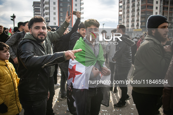 Syrian refugees living in the Onder district of Ankara, Turkey, celebrate the fall of Syrian President Bashar al-Assad after a rapid rebel o...