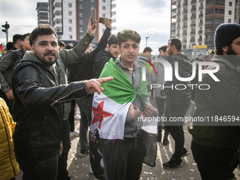 Syrian refugees living in the Onder district of Ankara, Turkey, celebrate the fall of Syrian President Bashar al-Assad after a rapid rebel o...