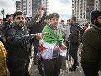 Syrian refugees living in the Onder district of Ankara, Turkey, celebrate the fall of Syrian President Bashar al-Assad after a rapid rebel o...