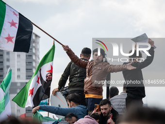 Syrian refugees living in the Onder district of Ankara, Turkey, celebrate the fall of Syrian President Bashar al-Assad after a rapid rebel o...