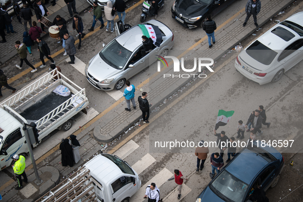 Syrian refugees living in the Onder district of Ankara, Turkey, celebrate the fall of Syrian President Bashar al-Assad after a rapid rebel o...