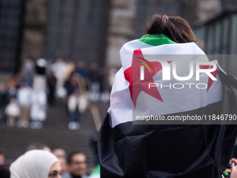 More than a hundred people spontaneously gather in front of Dom Cathedral to celebrate in Cologne, Germany, on December 8, 2024, as the rebe...