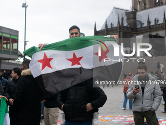 More than a hundred people spontaneously gather in front of Dom Cathedral to celebrate in Cologne, Germany, on December 8, 2024, as the rebe...