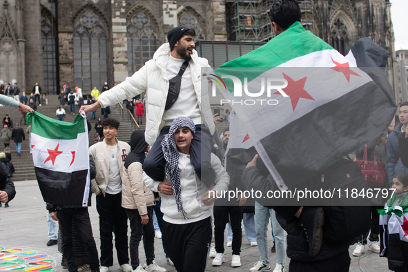 More than a hundred people spontaneously gather in front of Dom Cathedral to celebrate in Cologne, Germany, on December 8, 2024, as the rebe...