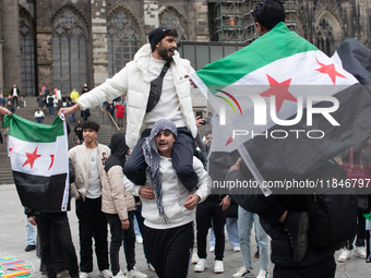 More than a hundred people spontaneously gather in front of Dom Cathedral to celebrate in Cologne, Germany, on December 8, 2024, as the rebe...