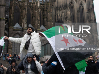 More than a hundred people spontaneously gather in front of Dom Cathedral to celebrate in Cologne, Germany, on December 8, 2024, as the rebe...