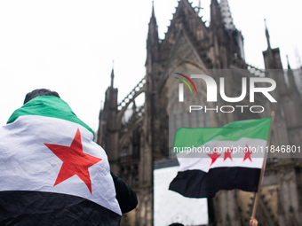 More than a hundred people spontaneously gather in front of Dom Cathedral to celebrate in Cologne, Germany, on December 8, 2024, as the rebe...