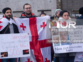 Dozens of people take part in a pro-EU demonstration for Georgia and support the crackdown in Georgia in Cologne, Germany, on December 8, 20...