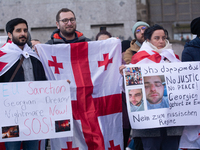 Dozens of people take part in a pro-EU demonstration for Georgia and support the crackdown in Georgia in Cologne, Germany, on December 8, 20...