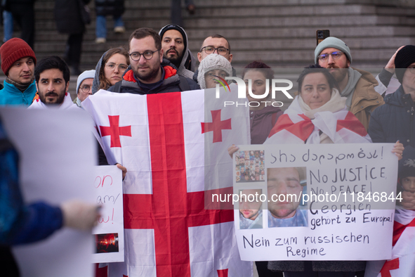 Dozens of people take part in a pro-EU demonstration for Georgia and support the crackdown in Georgia in Cologne, Germany, on December 8, 20...