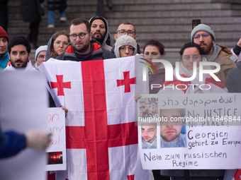 Dozens of people take part in a pro-EU demonstration for Georgia and support the crackdown in Georgia in Cologne, Germany, on December 8, 20...