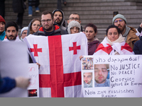 Dozens of people take part in a pro-EU demonstration for Georgia and support the crackdown in Georgia in Cologne, Germany, on December 8, 20...