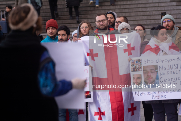 Dozens of people take part in a pro-EU demonstration for Georgia and support the crackdown in Georgia in Cologne, Germany, on December 8, 20...