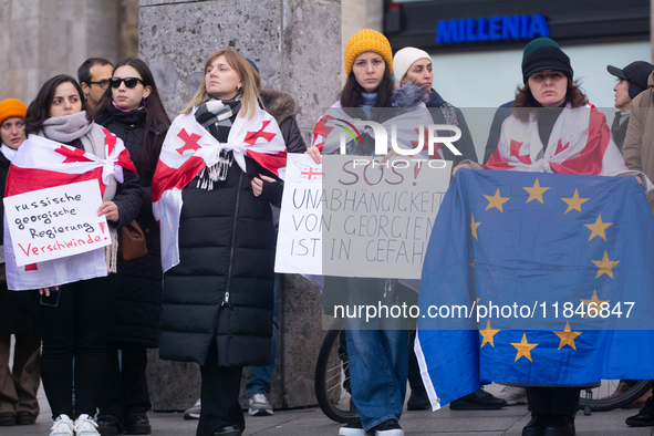 Dozens of people take part in a pro-EU demonstration for Georgia and support the crackdown in Georgia in Cologne, Germany, on December 8, 20...