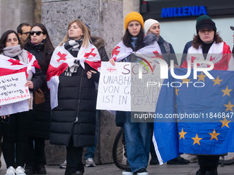 Dozens of people take part in a pro-EU demonstration for Georgia and support the crackdown in Georgia in Cologne, Germany, on December 8, 20...