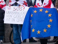 Dozens of people take part in a pro-EU demonstration for Georgia and support the crackdown in Georgia in Cologne, Germany, on December 8, 20...