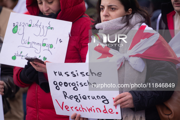 Dozens of people take part in a pro-EU demonstration for Georgia and support the crackdown in Georgia in Cologne, Germany, on December 8, 20...