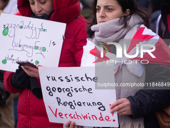 Dozens of people take part in a pro-EU demonstration for Georgia and support the crackdown in Georgia in Cologne, Germany, on December 8, 20...