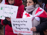 Dozens of people take part in a pro-EU demonstration for Georgia and support the crackdown in Georgia in Cologne, Germany, on December 8, 20...