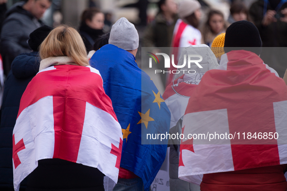 Dozens of people take part in a pro-EU demonstration for Georgia and support the crackdown in Georgia in Cologne, Germany, on December 8, 20...