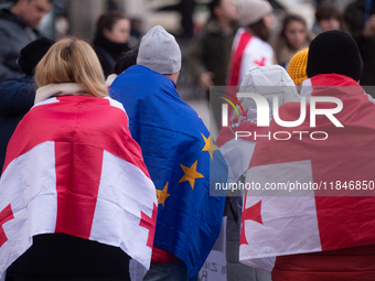 Dozens of people take part in a pro-EU demonstration for Georgia and support the crackdown in Georgia in Cologne, Germany, on December 8, 20...