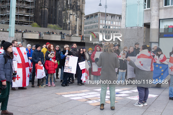 Dozens of people take part in a pro-EU demonstration for Georgia and support the crackdown in Georgia in Cologne, Germany, on December 8, 20...